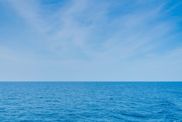 Beautiful sea landscape with blue sky and tiny clouds on sunny day