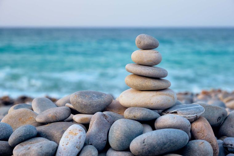 Zen balanced stones stack on beach.